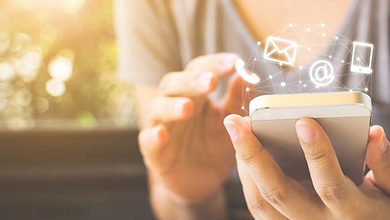 A hand operating a smartphone and an email, chat, or phone icon floating on the screen, suggesting an inquiry or means of contact.