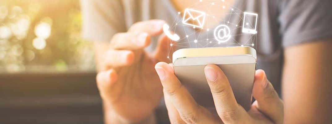 A hand operating a smartphone and an email, chat, or phone icon floating on the screen, suggesting an inquiry or means of contact.